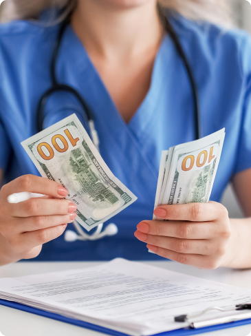 Nurse holding hundreds