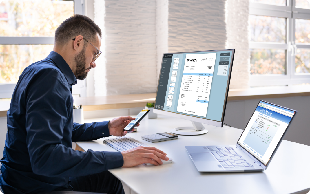 Man on phone in front of computer
