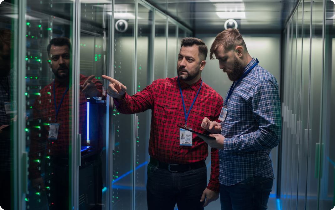 Two IT guys looking at servers